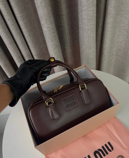 Deep espresso brown rectangular leather handbag with dual top handles.